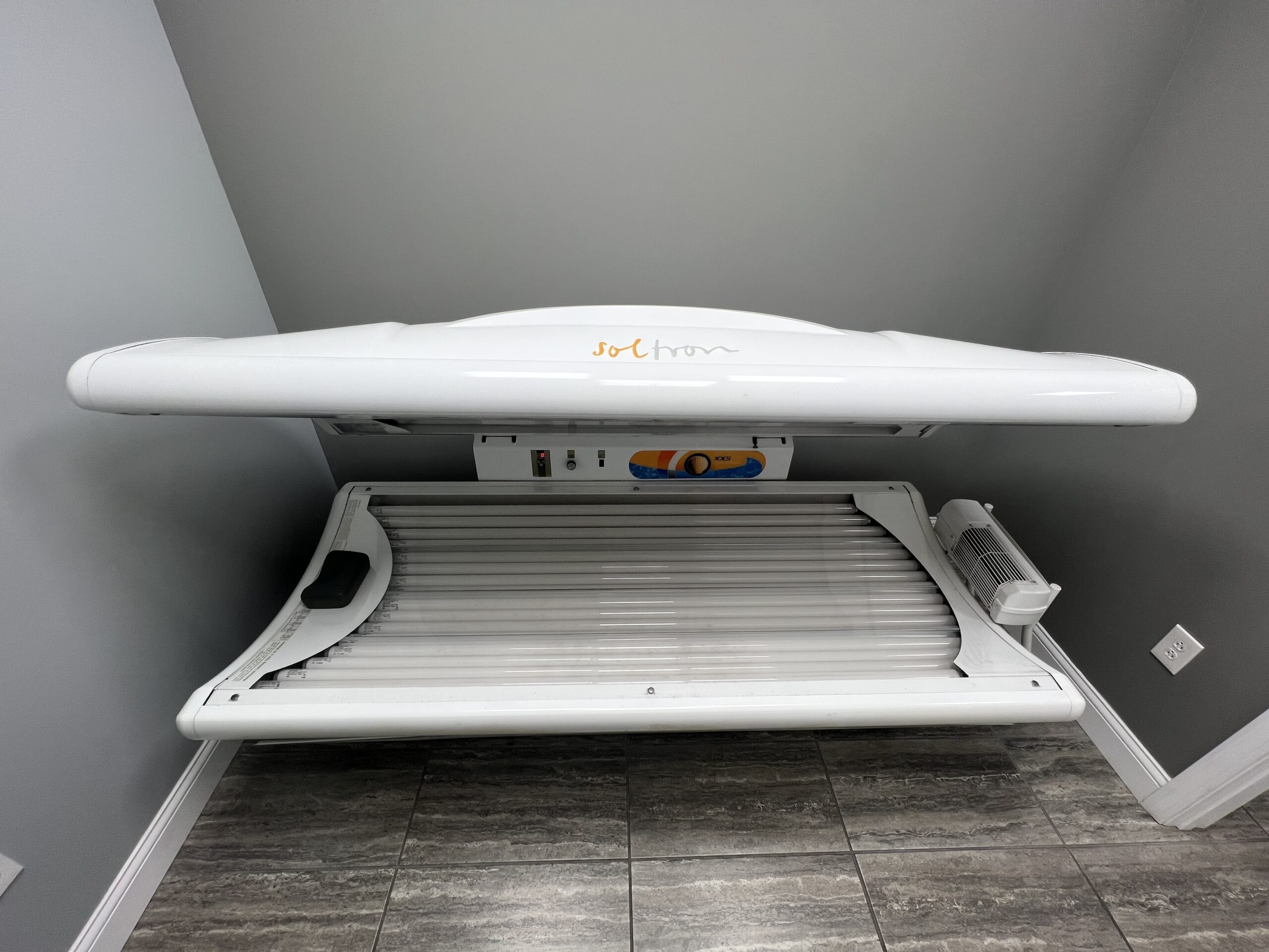 Sleek Soltron tanning bed at Key Largo Tan & Spa, East Alton, IL, offering a premium and efficient tanning solution for a sun-kissed look.